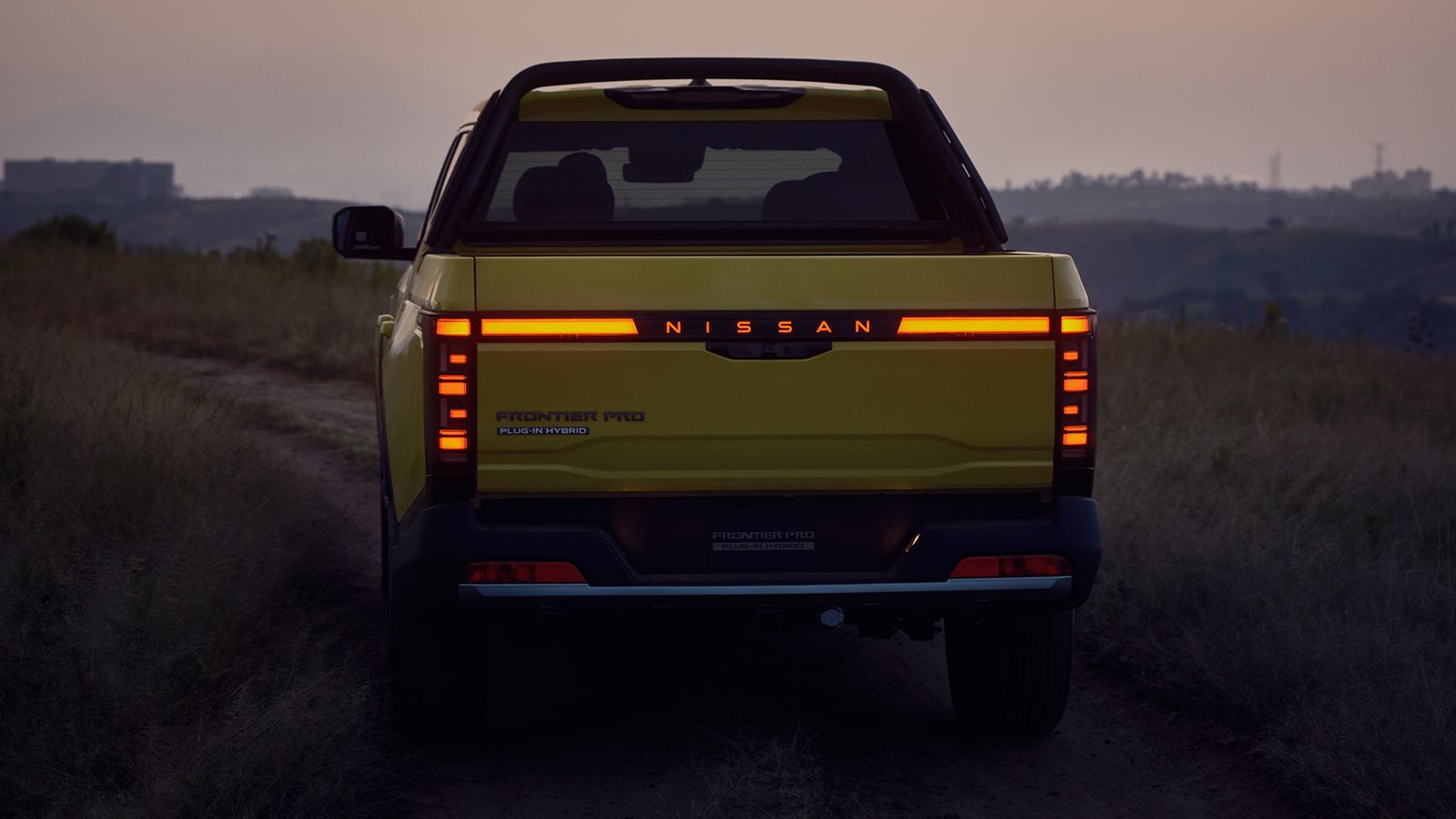 Πίσω όψη του Nissan Navara Pro στο σούρουπο με αναμμένα LED φωτιστικά σώματα.